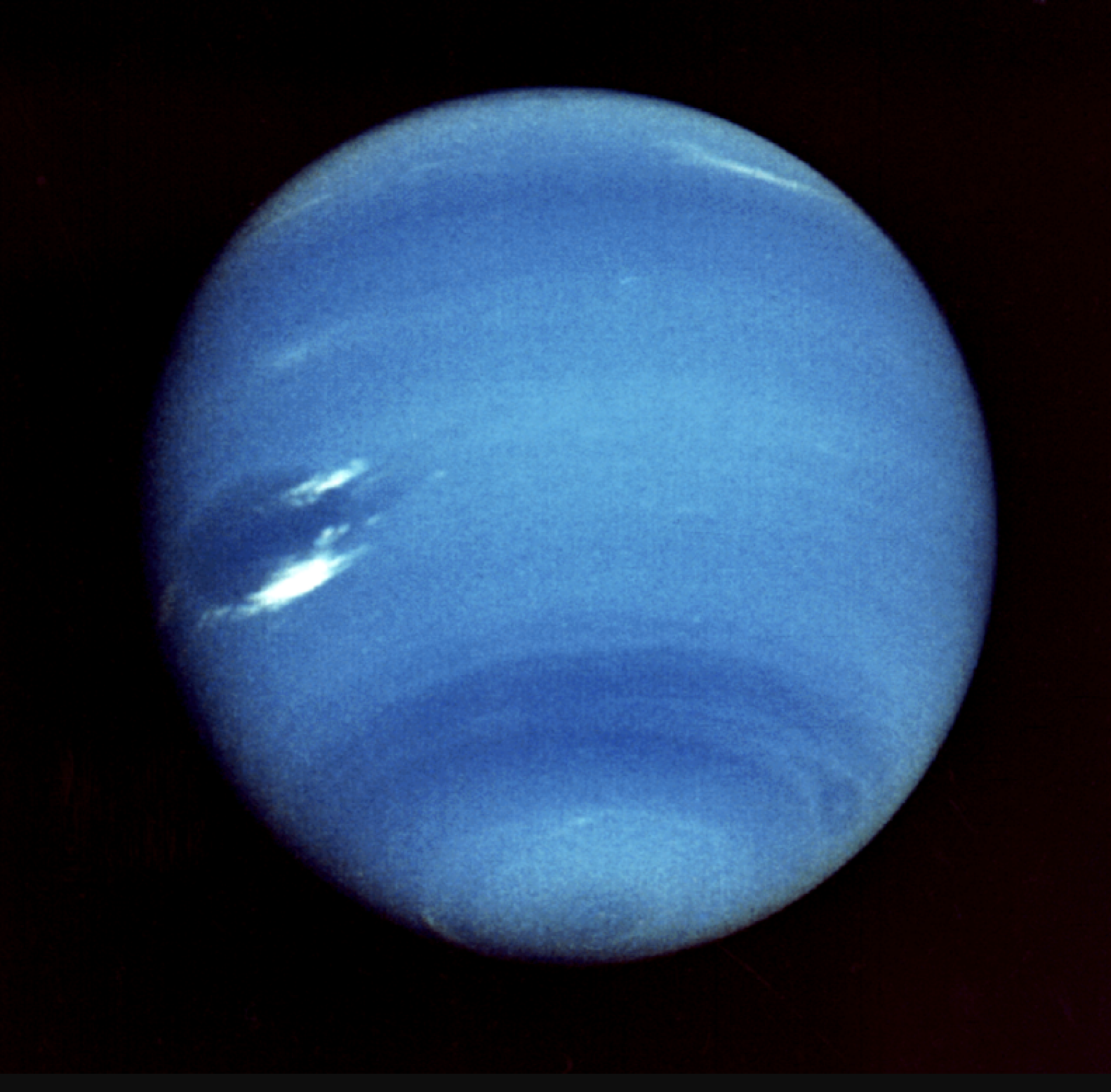 A view of Neptune from Voyager 2, taken in 1989. Strong streaks of wind are seen swirling through the atmosphere.